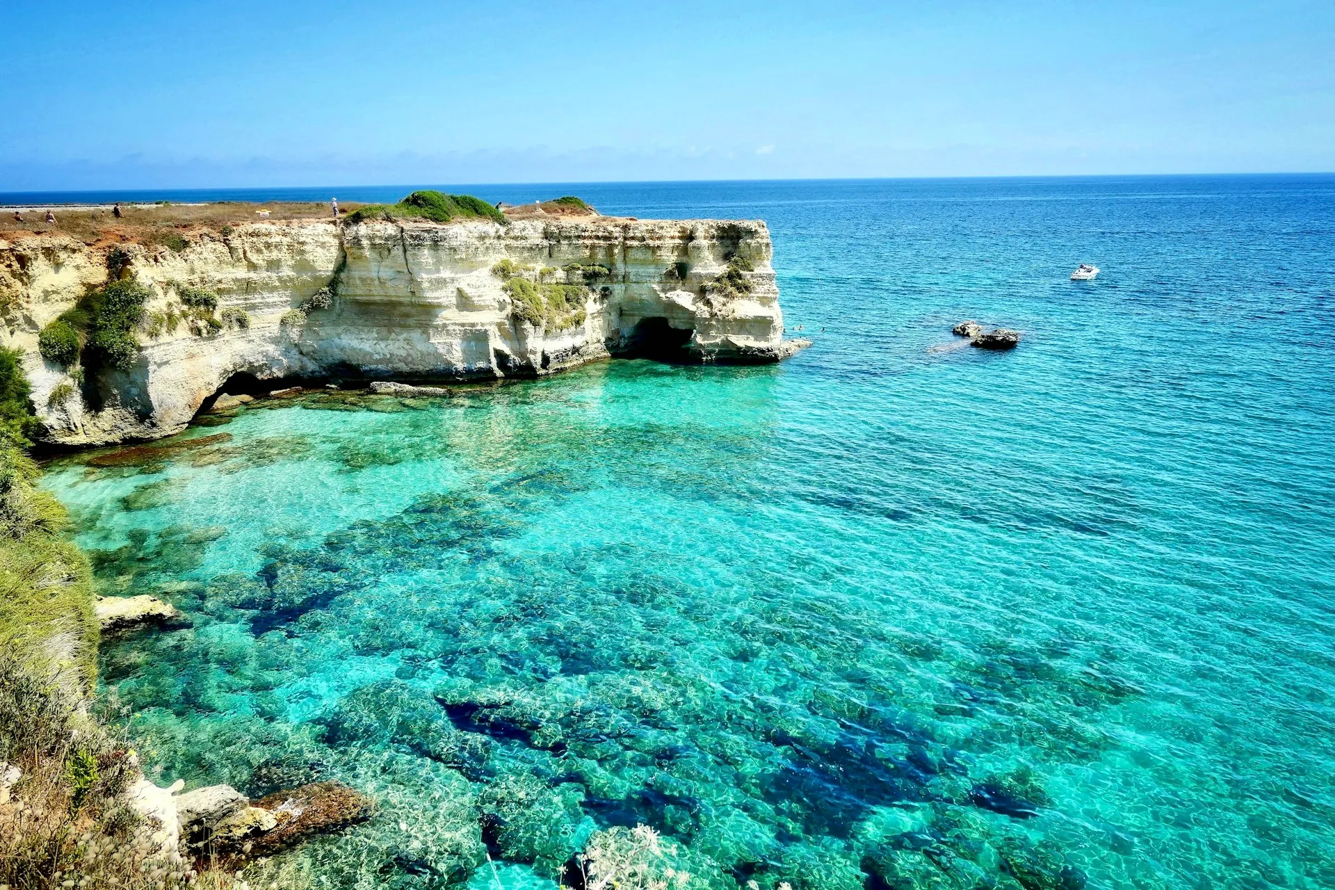 brown rock formation on blue sea during daytime